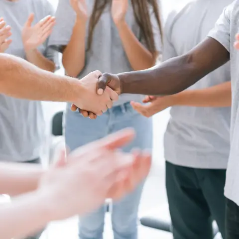 Group of young people shaking hands