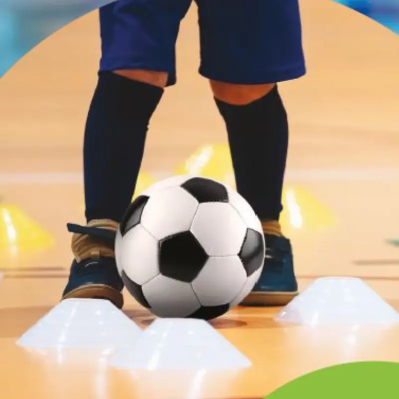 SEND Child football training around cones in gym