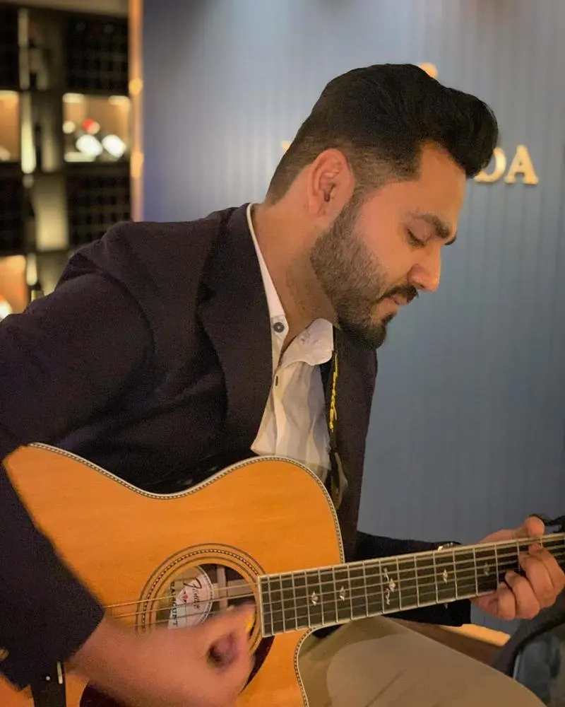 Male musician playing guitar