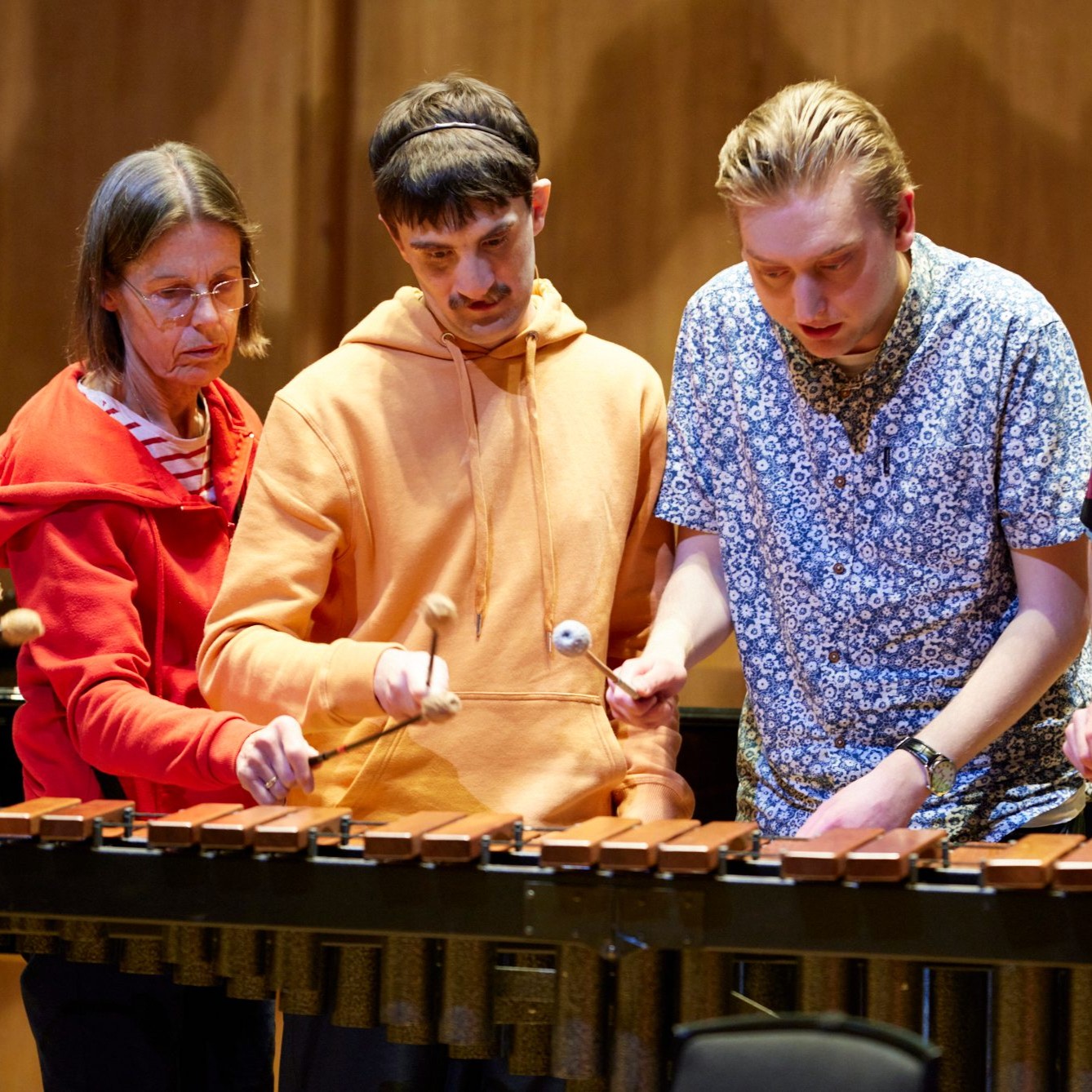 Neurodiverse adults with teacher playing xylophone